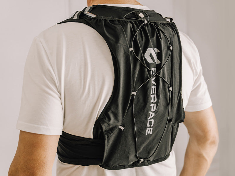 Person wearing a black Everpace vest over a white shirt