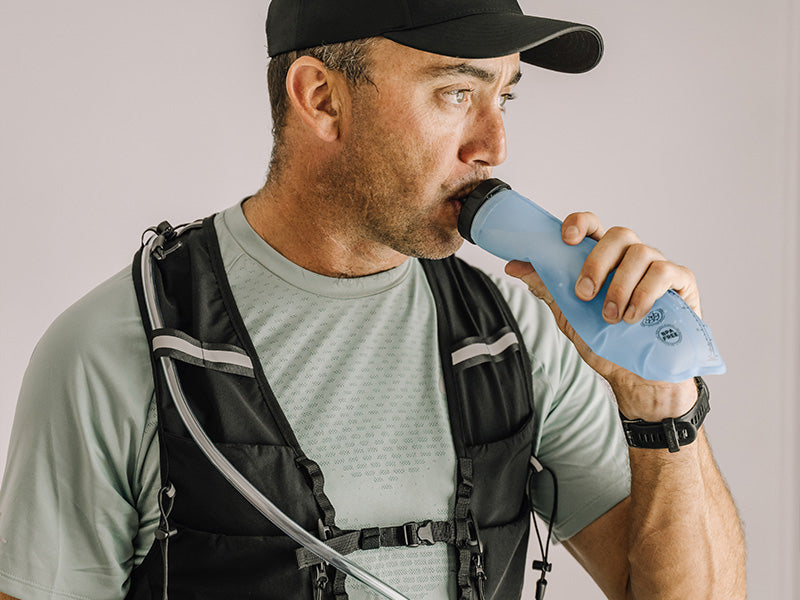 Man in athletic wear drinking from an Everpace soft flask