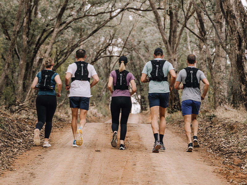 Five people trail running through regional Australian bushland